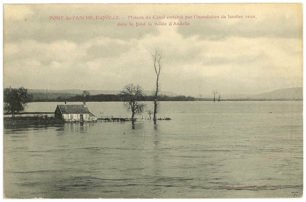 Carte postale 1910. Pont de l'Arche/Igoville - Maison du Canal envahie par l'inondation de janvier 1910, dans le fond de la vallée d'Andelle. Source : Collection Archives Départementales 27